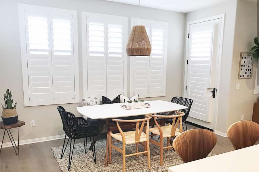 Use Polywood shutters to control natural light levels in your Miami dining room. Polywood shutters with top louvers tilted open in a dining room