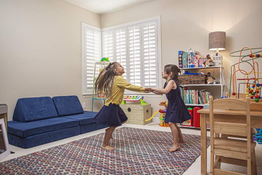 Choose Polywood shutters for durable, kid-friendly great room window treatments in Miami. Polywood shutters on multiple windows in a sitting area