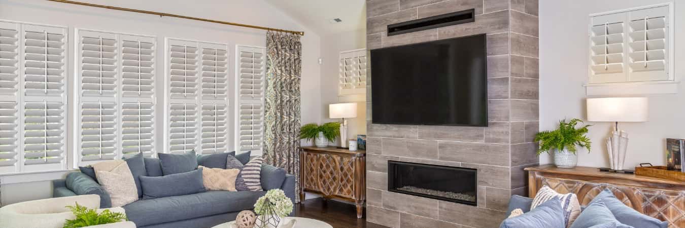 Interior shutters in Palmetto Bay family room with fireplace
