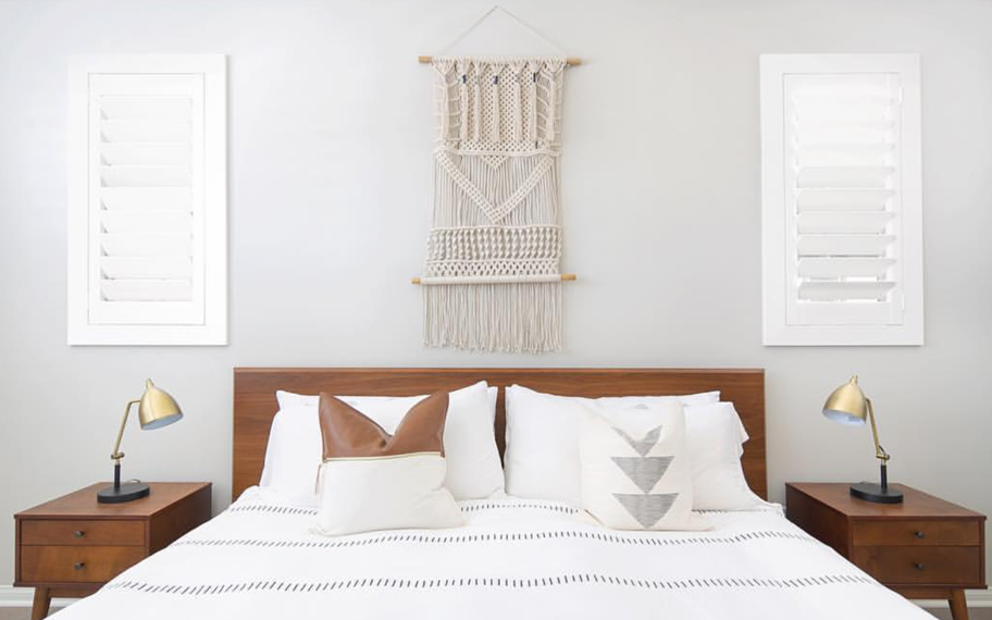 Custom-fitted louvered shutters provide excellent nighttime privacy in Miami. Photo Credit: Audrey Crisp Louvered shutters in a bedroom.