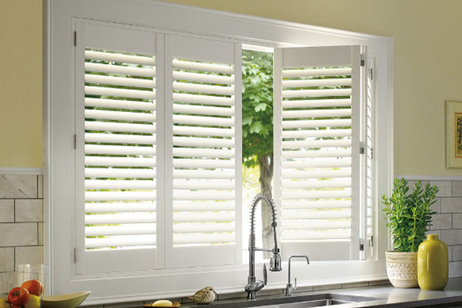 Polywood shutters are built to withstand the test of time in Miami. White Polywood shutters above a kitchen sink.