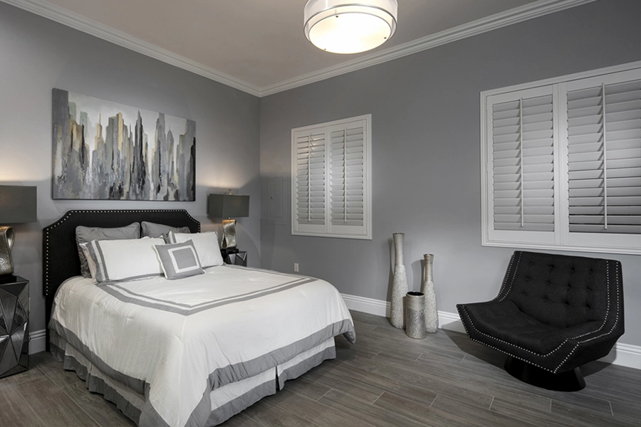 Close your custom Polywood shutters to beat the heat and keep your Miami bedroom cool. White Polywood shutters on bedroom windows
