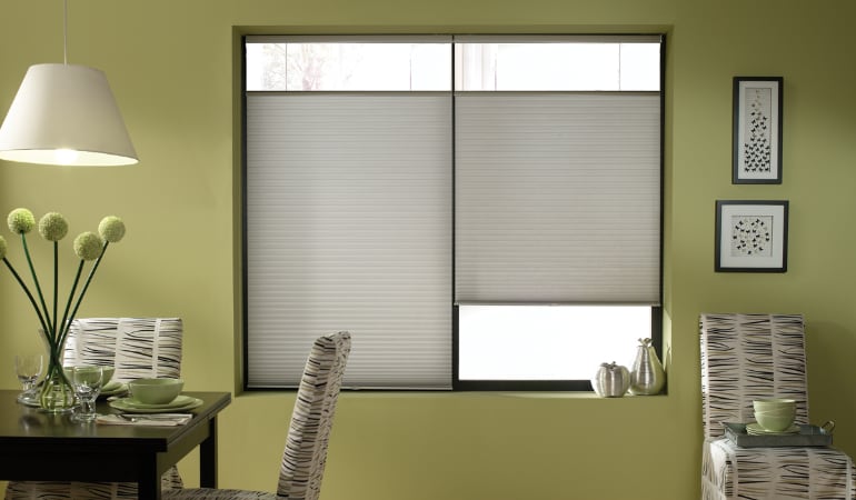 Cellular shades will keep a room's temperature consistent and reduce energy costs. Cellular shades in a Miami dining room