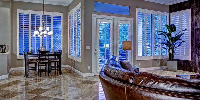 Photo Courtesy of Room Resolutions Miami great room with classic shutters and modern lighting.
