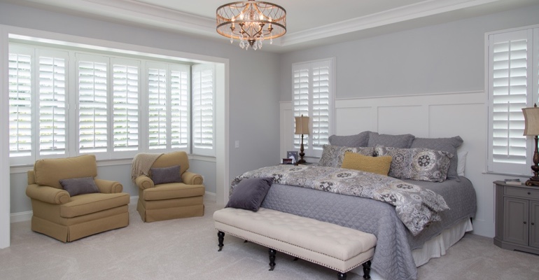 Indoor shutters offer subtle fashion. Interior shutters in Miami bedroom.