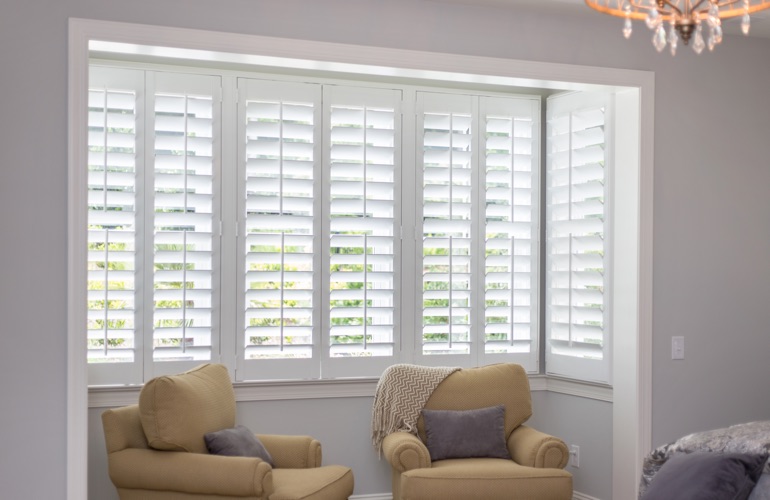 North-South windows may have energy efficiency issues instead of issues with sun glare. White plantation shutters in sitting area