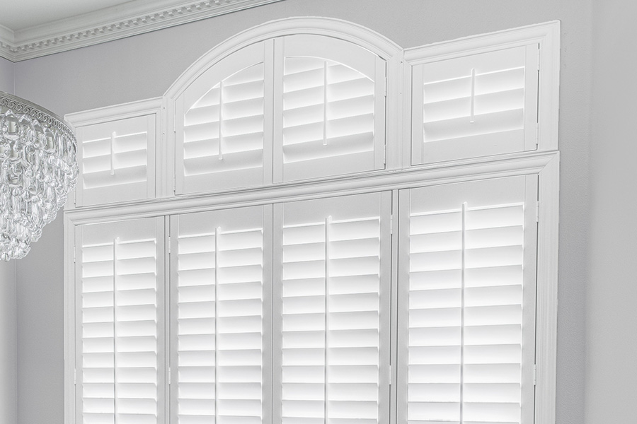 Customize your Palladian windows with white Polywood shutters in Miami. White Polywood Palladian windows in a dining room.