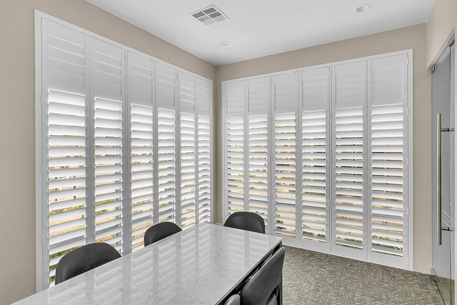 Custom options let you get the look and functionality you want from your shutters. White Polywood shutters with a split tilt function on two large windows.